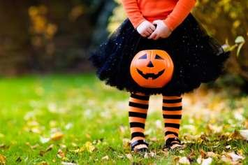 A little girl trick-or-treating on Halloween.  © Can Stock Photo / famveldman