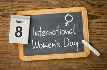 "International Women's Day" written on a chalkboard. © Can Stock Photo / zerbor