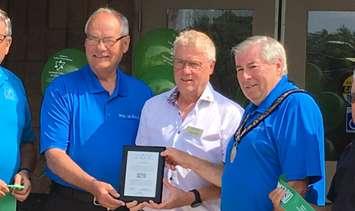 L-R: Perth-Wellington MPP Randy Pettapiece, Trillium Foundation rep Wayne White, and Minto Mayor George Bridge show off the plaque from Trillium commemorating their grant for the new accessible doors on the Harriston-Minto Community Centre. August 10th, 2017 (Photo by Ryan Drury)