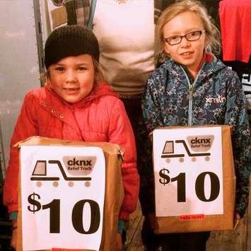 Addison and Paige Stevenson donating to the CKNX Relief Truck.