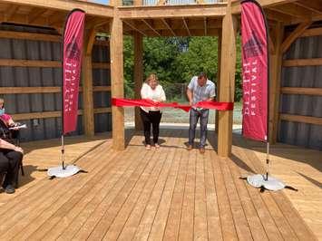 Huron-Bruce MPP Lisa Thompson (left) and Artistic Director Gill Garratt cut the ribbon to officially open the outdoor theatre stage in Blyth on August 11, 2021. (Photo by Bob Montgomery)