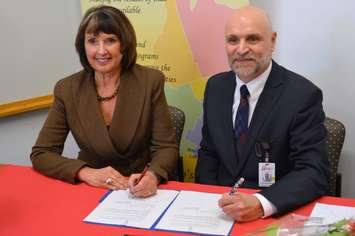 Gwen Devereaux, President of Gateway Centre of Excellence in Rural Health [L] and Paul Rosebush, President and CEO of South Bruce Grey Health Centre sign a collaboration agreement between the two organizations. (Photo by Jordan MacKinnon)