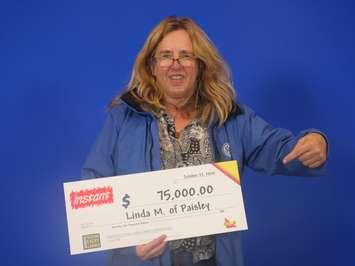 Linda McCleery of Paisley with her $75,000 cheque for buying a winning Instant UNO lotto ticket. (Photo provided by the OLG)
