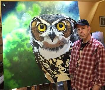Scott Ramsay is one of the artists who will be participating on the Art Gallery Showcase. He
is seen here with his acrylic painting “The Watcher”. Scott and his wife Cat O’Donnell operate
the Wonky Frog Studio in Blyth. (Photo courtesy of the Blyth Festival Art Gallery)