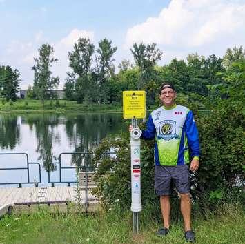 Volunteer Matt Fryer, from Lucan, installs the Fishing Tackle Recycler receptacle, donated by Blue Fish Canada, at Morrison Dam Conservation Area. Photo by Bob Montgomery.