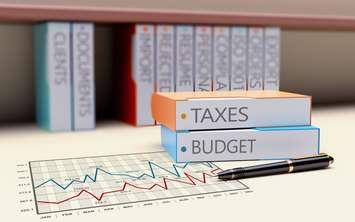 Office folder with the theme of taxation and finance. © Can Stock Photo / Violka08