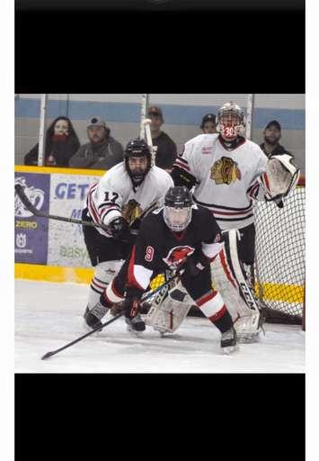 Brock Baier in the Mitchell Hawks crease, stopping pucks from the Walkerton Hawks.