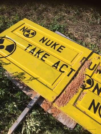 A sign damaged by chainsaw belonging to the Protect Our Waterways-No Nuclear Waste group, who are opposed to the DGR project coming to South Bruce. (Photo provided by the Protect Our Waterways group.)