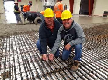  (L-R) Robert “Butch” Johnson and Harold “Hardy” Henry place coins at centre ice before the Southampton Coliseum floor pour.