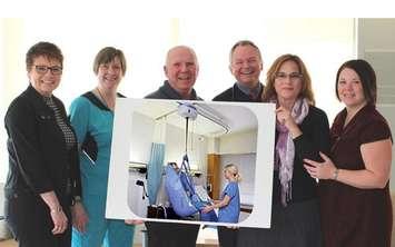 (Left to right)  Jane Rundle, Manager of Medicine HPHA (CPH & SMMH Sites);   Barb Levy, RN, Team Lead;  Larry Beattie, Auxiliary President;   Dr. Bob Davis;   Cathie Szmon, Gift Shop Coordinator Volunteer;   and Cheryl Hunt, Corporate Lead Volunteer Services pose with a photo of the ceiling lift purchased by the SMMH Auxiliary.
Photo submitted.