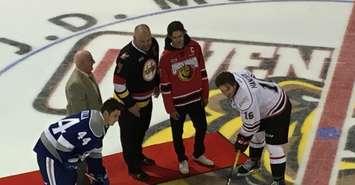 The Owen Sound Attack celebrated the 30th anniversary of OHL hockey in the city Saturday night with a special ceremonial faceoff. Attack Business Manager Ray McKelvie, left, joins original Owen Sound captain Mike Speers (dark jersey) and his son Ben (red Attack jersey) at centre ice. Attack captain Kevin Hancock and Sudbury captain Cole Candella take the draw. September 22nd, 2018 (Photo by Ryan Drury)