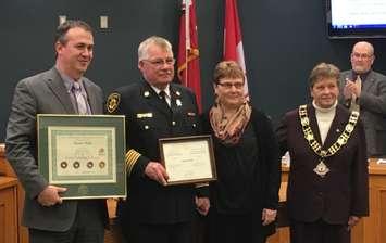 From L-R: North Perth CAO Kris Snell, North Perth Fire Chief Ed Smith, Ed's wife Heather Smith, and Mayor Julie Behrns stand with the awards given to Chief Smith for his over 40 years of fire service. (Photo by Ryan Drury)