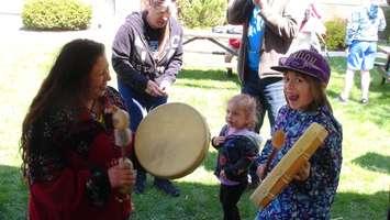 Cape Croker's Sheila Robson and Seven Year old Brigitte Galbrith of Meaford play drums together at the One World Festival in Owen Sound. (Photo by Kirk Scott)