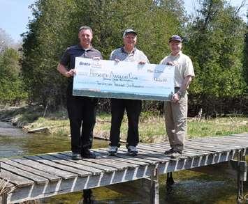 Dwight Irwin, left, Bruce Power’s Community Investment and Sponsorship Lead, presents a $22,600 cheque to Bill Nafziger, middle, of the Hepworth Anglers Club, and Dr. James Hamilton, Associate Professor of Geography and Environmental Studies at Wilfrid Laurier University, for improvement work on Spring Creek, near Hepworth. 
Photo submitted