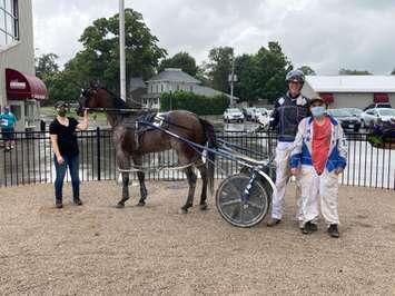 Therubberduckie was the first of the day on August 2, 2020, to visit the winner's circle for driver Daryl Thiessen and owner/trainer Jeffrey Williamson of Blyth. (Photo courtesy of Clinton Raceway)