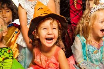 Children laughing in Halloween costumes. Canstock Photo @serrnovik