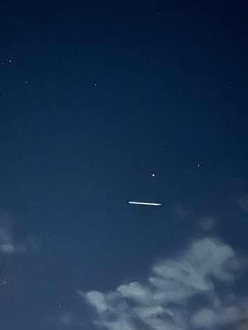 Starlink satellites streak across the sky. Photo courtesy of Brittany Forrest via Facebook.