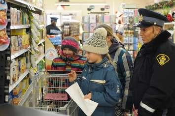 Students from Kenilworth Public School go shopping Thursday to help stock a food bank. (Wellington County OPP photo)