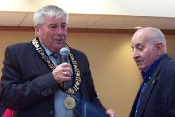 Minto Mayor George Bridge presents the Town of Minto Award of Appreciation to Doug Anderson (right) for his many years of volunteer service.  (photo by Campbell Cork)