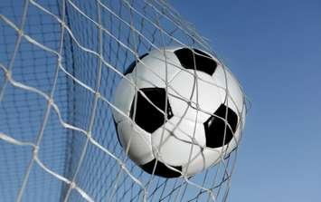 Soccer ball going into a net. © Can Stock Photo Inc. / mikdam