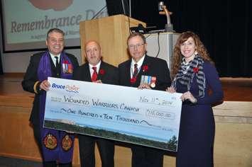 Philip Ralph, left, National Program Director for Wounded Warriors Canada, accepts a $110,000 cheque from Duncan Hawthorne, Bruce Power President and CEO, Harry Hall, Vice President, Supply Chain, and Crystal Shepherd, Personal Assistant to Harry Hall, during Bruce Power’s Remembrance Day ceremony on Nov. 11. (Submitted Photo)