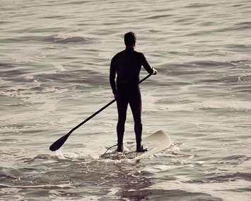 A person paddle boarding. File photo courtesy of © Can Stock Photo / robwilson39