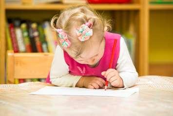 Cute child girl drawing with colourful pencils in preschool at the table in kindergarten
© Can Stock Photo / vitmark
