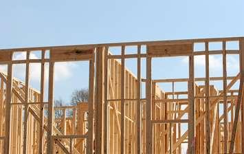 Wood framing in the early construction of an apartment complex. © Can Stock Photo / dbvirago