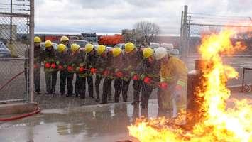 Dignitaries get a hands on demonstration of how to fight a fire at Georgian College's Marine Safety Training Centre.  (photo by Kirk Scott)