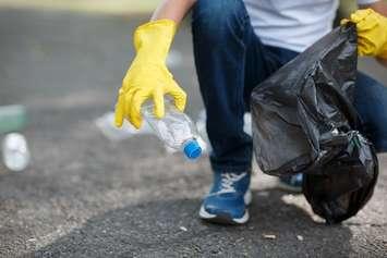 File photo of a person picking up litter courtesy of © Can Stock Photo / AlfaStudio. 
