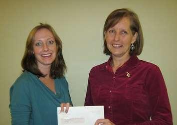 Tiffany Love (left) of Women's House accepts a cheque from Sue MacLeod (right) of Bruce Power
