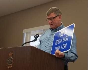 Ron Horst of the Golden Triangle Snowmobile Club shows off the new signs being posted on many Perth County snowmobile trails.
(Photo by Victor Young) 