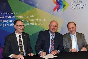 (Left-to-right) Graham Wren [University of Strathclyde's director of major projects and special adviser to the principal and vice-chancellor], Mitch Twolan [Bruce County warden] and Frank Saunders [President of Ontario's Nuclear Innovation Institute] sign the memorandum of understanding. (photo by Jordan MacKinnon)