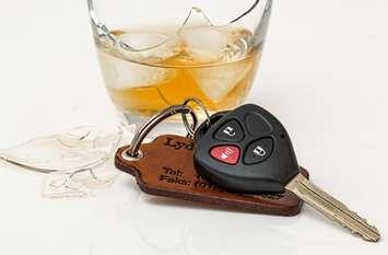 Car keys next to a broken glass of alcohol. (Photo from Pxhere)