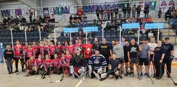 Central Huron Secondary Students and local Huron County OPP officers celebrating a great afternoon of ball hockey at the Eastlink Arena in Clinton, which raised food donations for the local food banks. (Photo courtesy of Provincial Constable Craig Soldan)