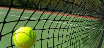 Tennis ball hits net. © Can Stock Photo Inc. / mflippo