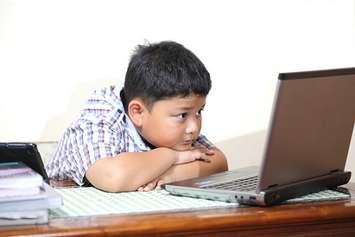 A child learning online. File photo courtesy of © Can Stock Photo / myrainjom01