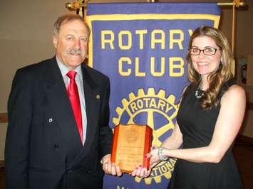 Amy Teed-Acres holds a specially made plaque presented to her by Rotarian Bernard Brunner. Brunner is the chair of the Meaford Rotary Club committee that chose her at Citizen of the Year for 2014. Photo by Jim Armstrong