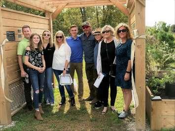 Members of the Winters family, at the arbour at the entrance to the Woods. This arbour, with a mounted sign saying Winters Walk, is in memory of Hank Winters, one of the founders of the Lakeshore Eco-Network, who was the inspiration for this project. (Submitted photo)