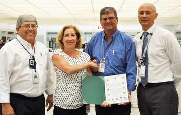 Kim Rudd, Parliamentary Secretary for the Minister of Natural Resources and Member of Parliament for Northumberland-Peterborough South, presents a certificate of appreciation to Bruce B staff on the new long-run record for Unit 7, which surpassed its previous record of 465 consecutive days of operation on Aug. 19 and is currently at 478 days and counting. With the Parliamentary Secretary is Pierre Pilon, left, Senior Vice President, Bruce B; Steve McConville, Control Room Shift Supervisor, Bruce B; and Mike Rencheck, President and Chief Executive Officer. (Photo Contributed by Bruce Power, © 2016).