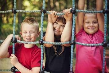 File photo of children at a playground courtesy of © Can Stock Photo / gpointstudio