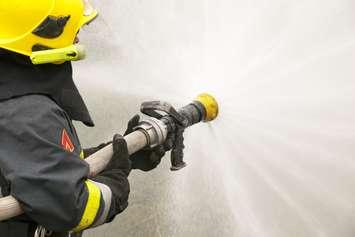 Firefighter in action. © Can Stock Photo / wellphoto