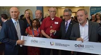 Organization of Canadian Nuclear Industries President Ron Oberth [second from right] and Chippewas of Nawash Unceded First Nation Chief Greg Nadjiwon [centre] cut the ribbon to open the OCNI office in Port Elgin, with Bruce Power President and CEO Mike Rencheck [far left] and Saugeen Shores Mayor Mike Smith [far right] (Jordan MacKinnon photo) 