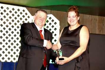 Goderich Chamber Operations Manager Mark Woodward, left, presents the Business of the Year award to Nicole Mackechnie of Sweet Love Eats. (Photo by Bob Montgomery) 